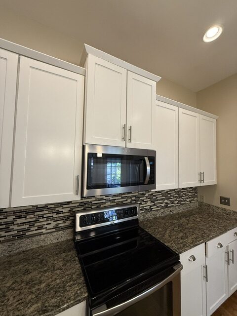 Freshly painted white kitchen cabinets by port city painting co in wilmington north carolina